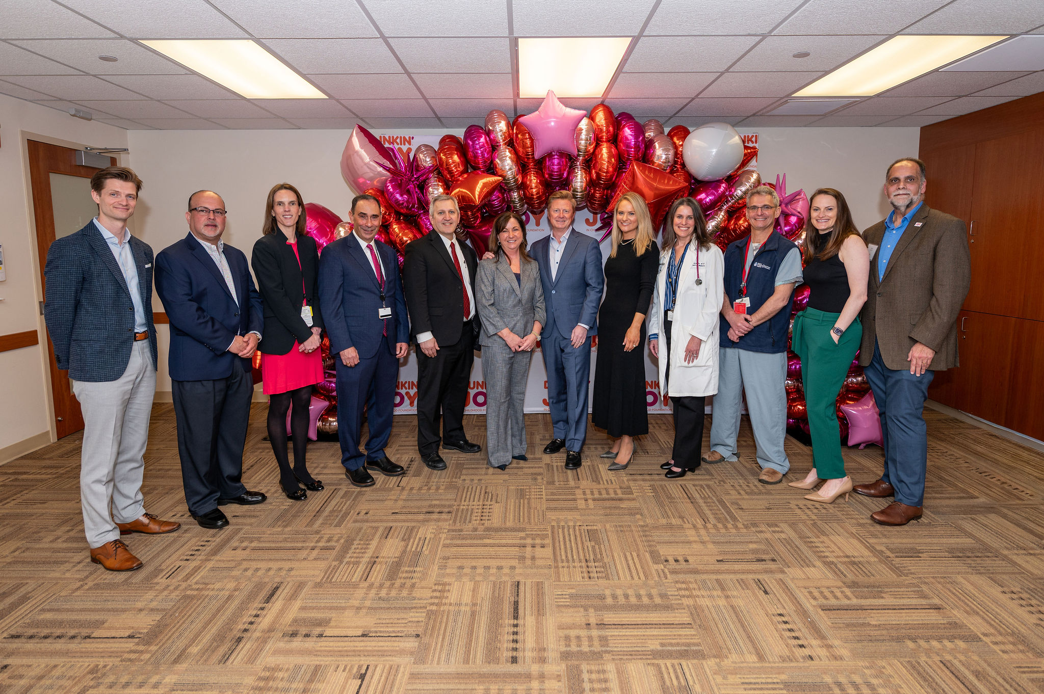 Group photo of representatives from Dunkin, joy in childhood, and south shore health