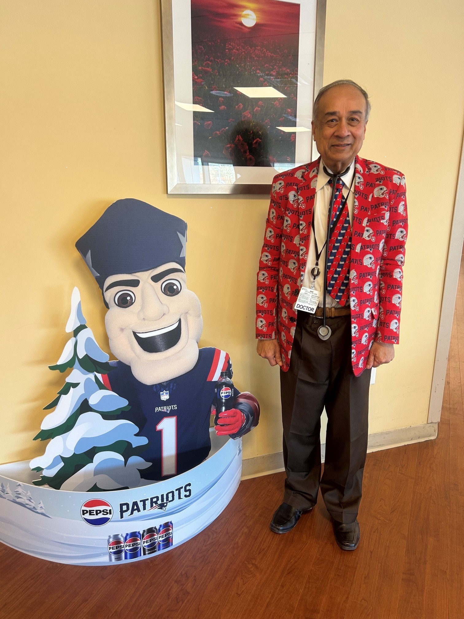 Dr. Rau poses with Pat Patriot at the South Shore Hospital dining room.