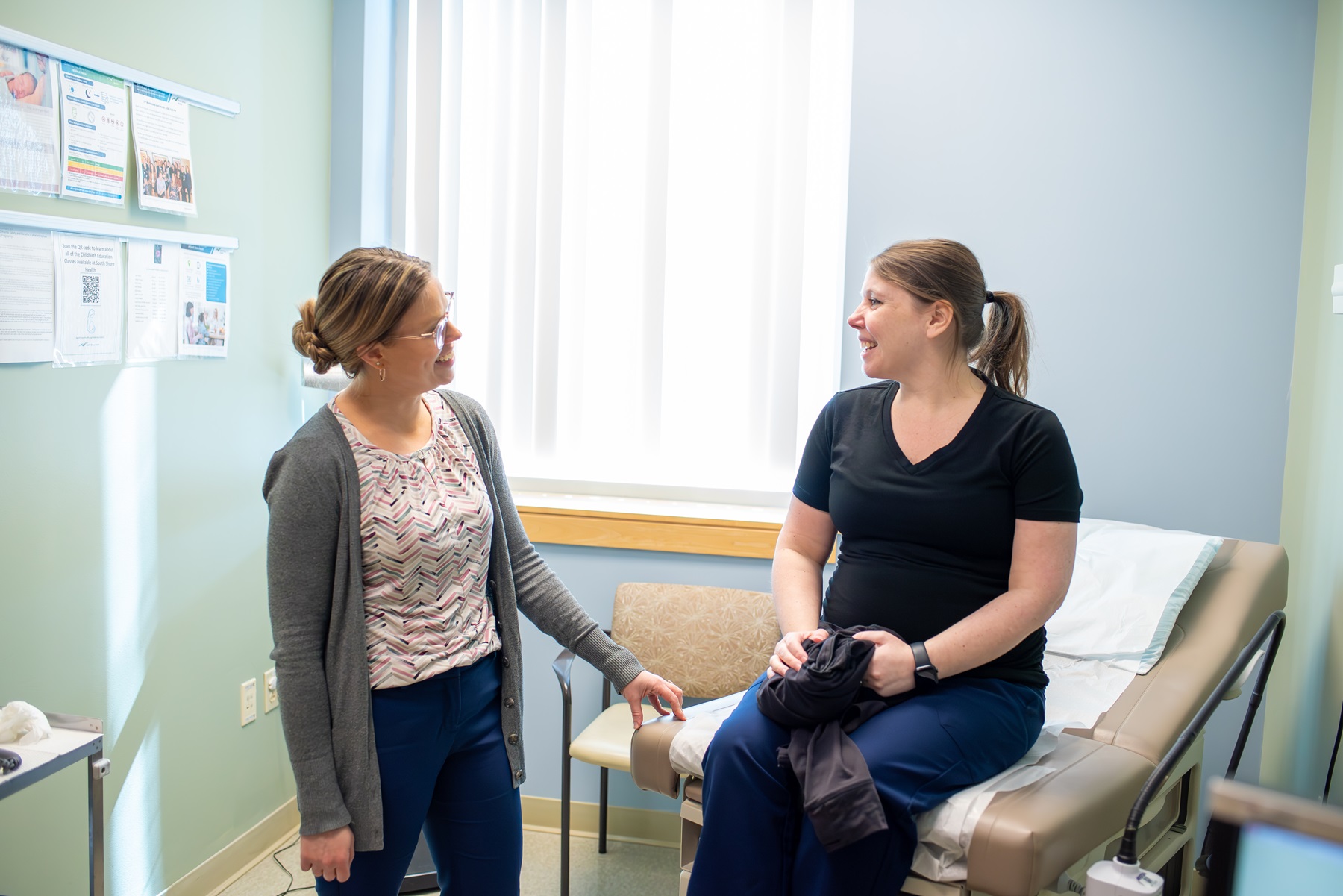 An OB/GYN provider speaks with a female patient
