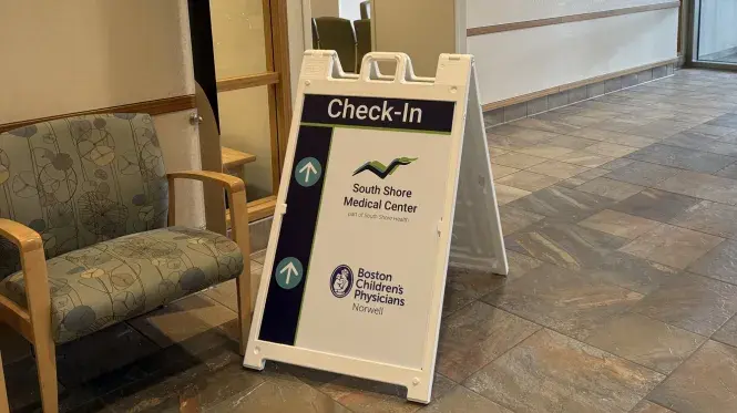 Check in sign at South Shore Medical Center Norwell with South Shore Medical Center and Boston Children's Physicians Norwell logos