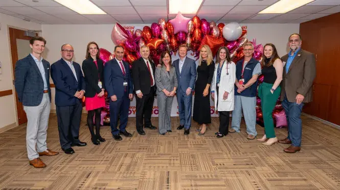 Group photo of representatives from Dunkin, joy in childhood, and south shore health