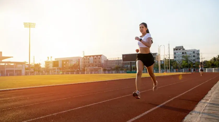 A female student athlete runs on a track