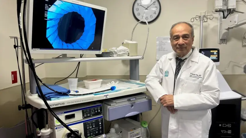 Dr. Rau in front of a monitor in the endoscopy suite at South Shore Hospital