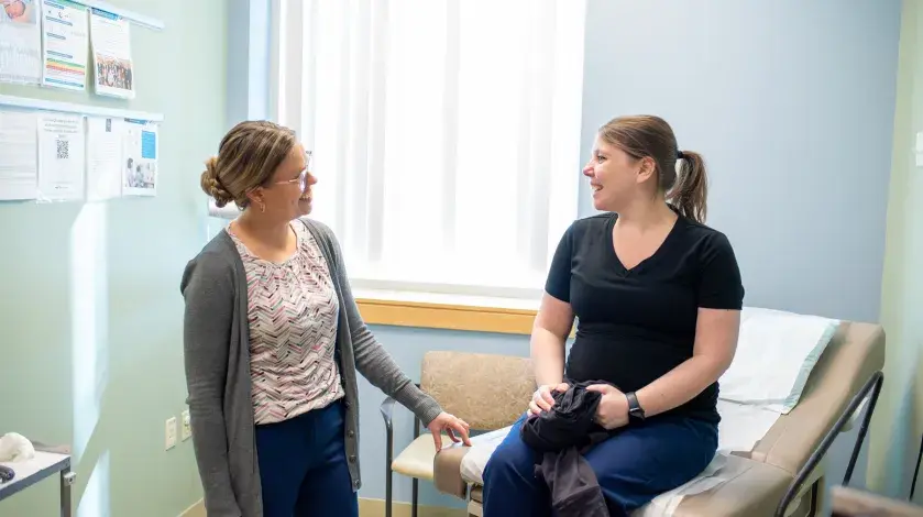 An OB/GYN provider speaks with a female patient