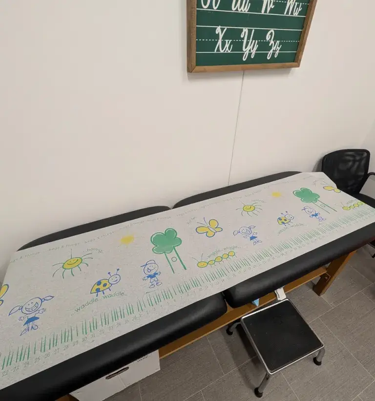 Close-up of kid-themed exam table paper at South Shore Health Urgent Care Braintree