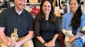 Three certified hand therapists from South Shore Health pose for a group photo.