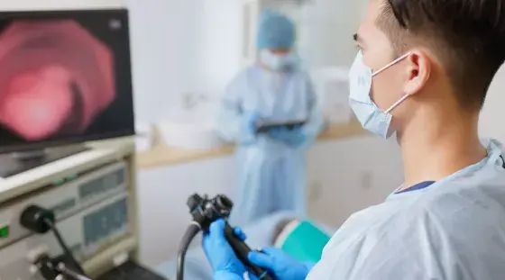 A provider watching a monitor during a colonoscopy