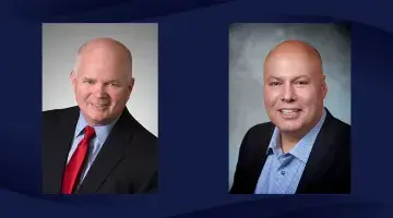 Photos of Mark Flaherty and Richard Russell on a navy blue wave patterned background